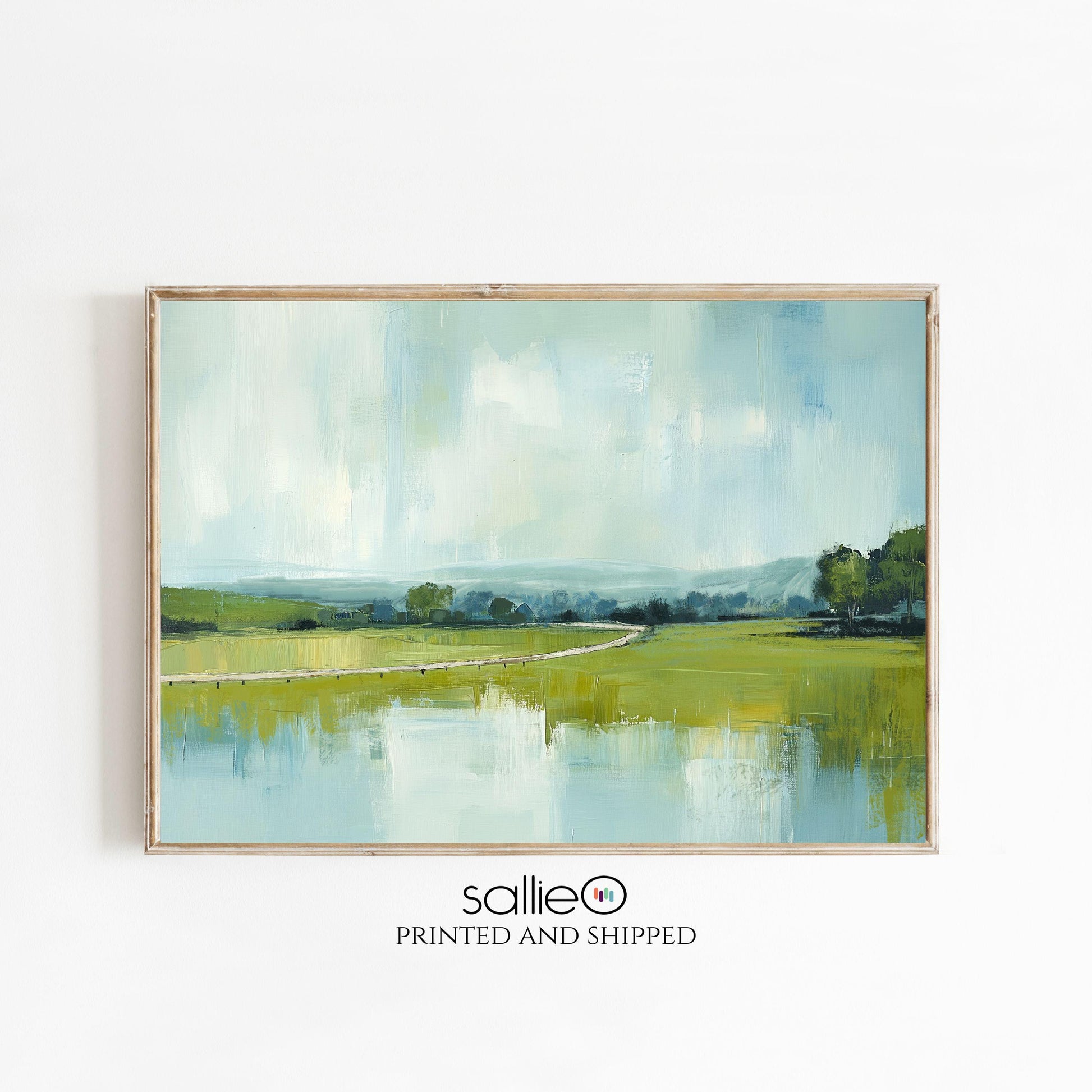 Peaceful countryside landscape painting with soft blue sky, distant hills, and winding path through lush green fields reflected in calm water, modern rustic farmhouse wall art.